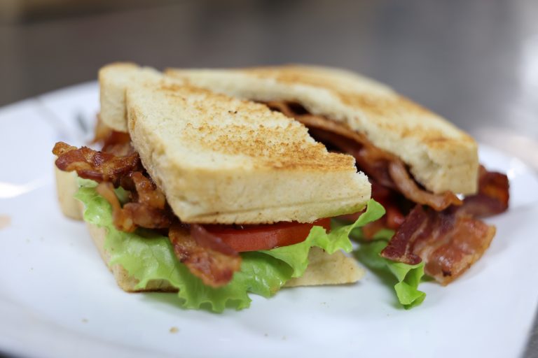 Grilled sandwich with lettuce and sliced meat on toasted bread